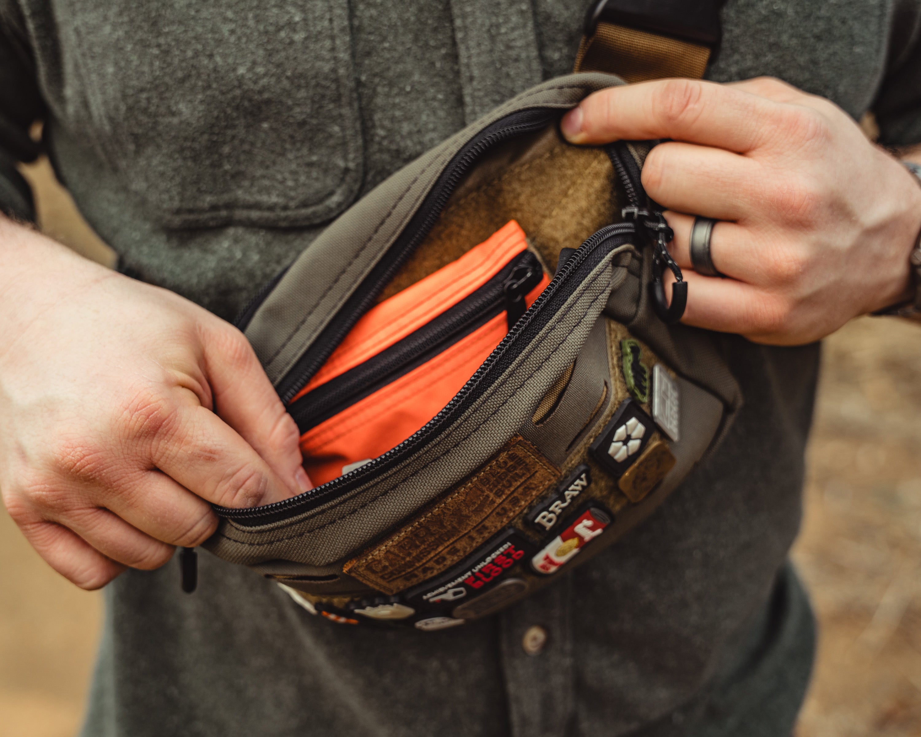 Carry Commission / Blue Ridge Overland Gear Bum Bag XL being modeled with the top zipper open to showcase the interior storage capability
