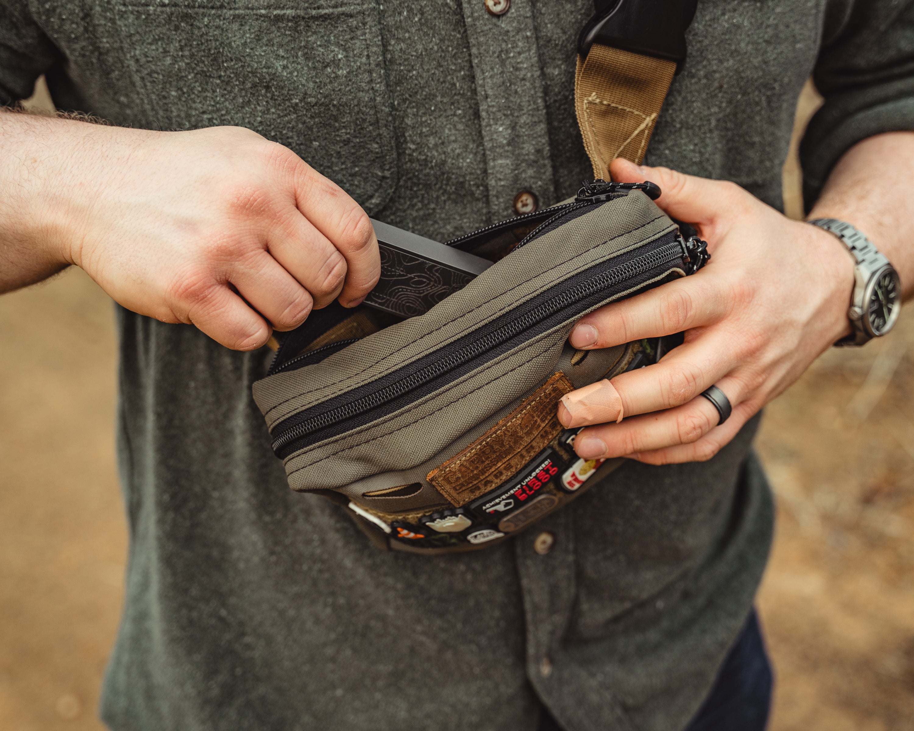 Carry Commission / Blue Ridge Overland Gear Bum Bag XL being modeled to show the capacity of the zippered storage compartment on the back