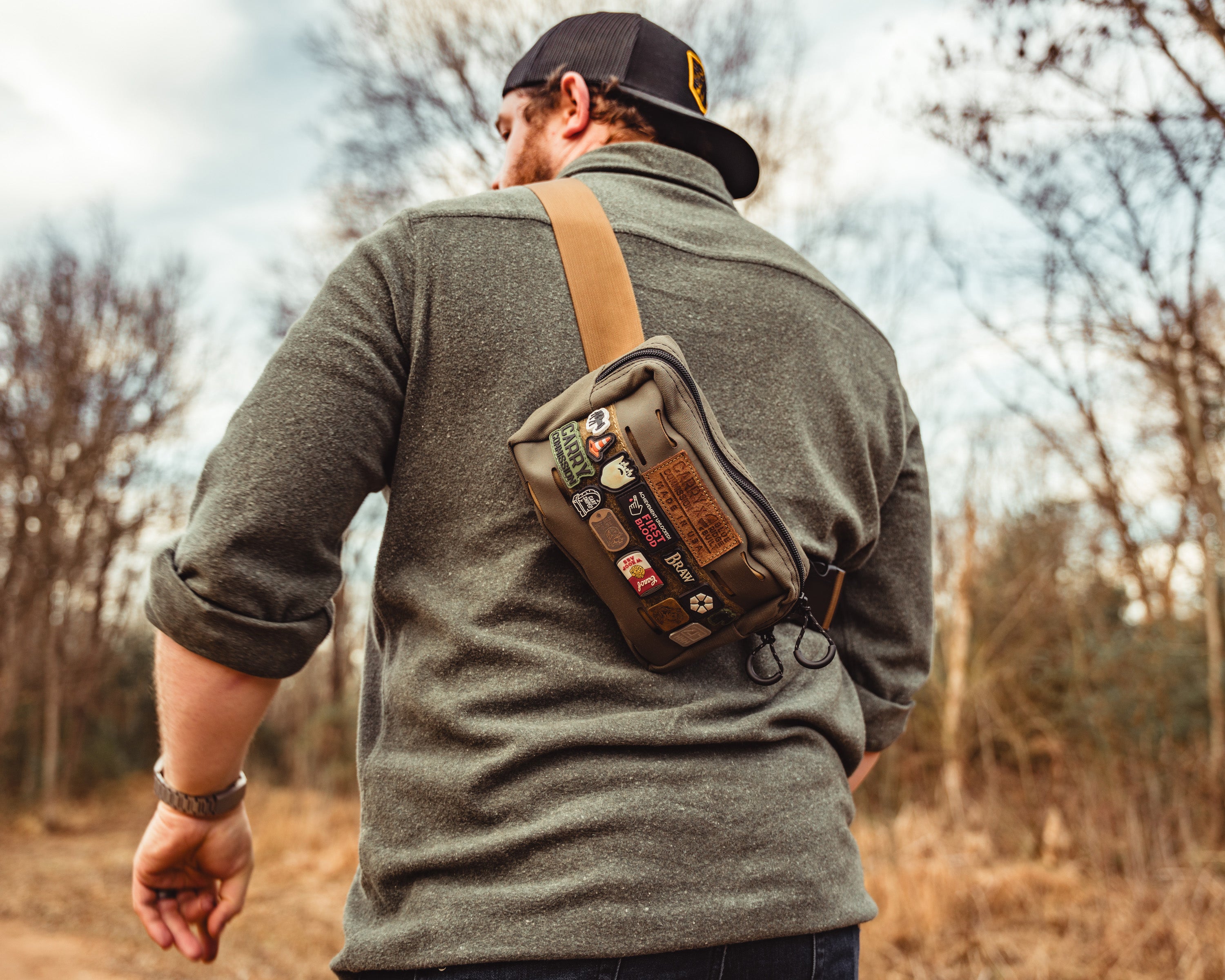Carry Commission / Blue Ridge Overland Gear Bum Bag XL being modeled as an over the shoulder sling with lots of ranger eye patches on the front hook and loop strip