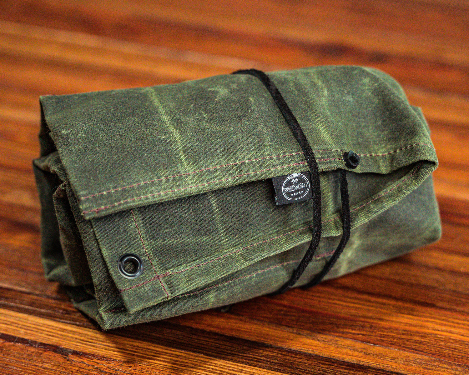 Birch Waxed Canvas Knife Roll rolled up with the leather closure
