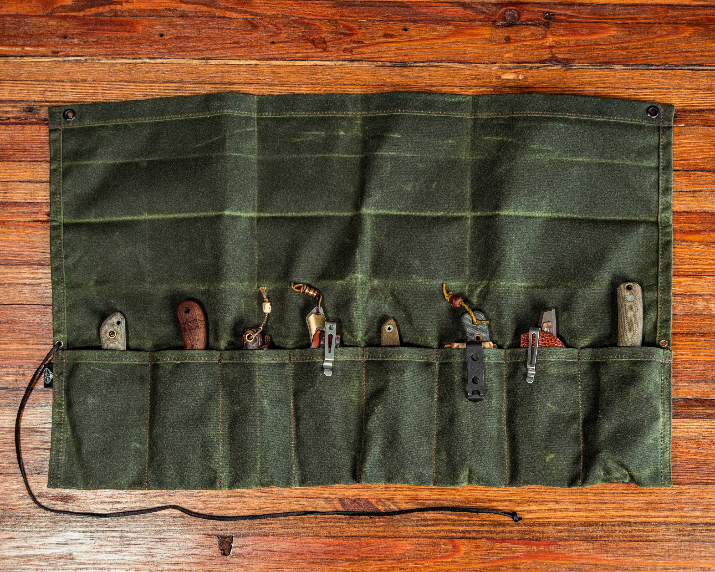 Birch Waxed Knife Roll overhead view on wooden background fully open with knives stored inside