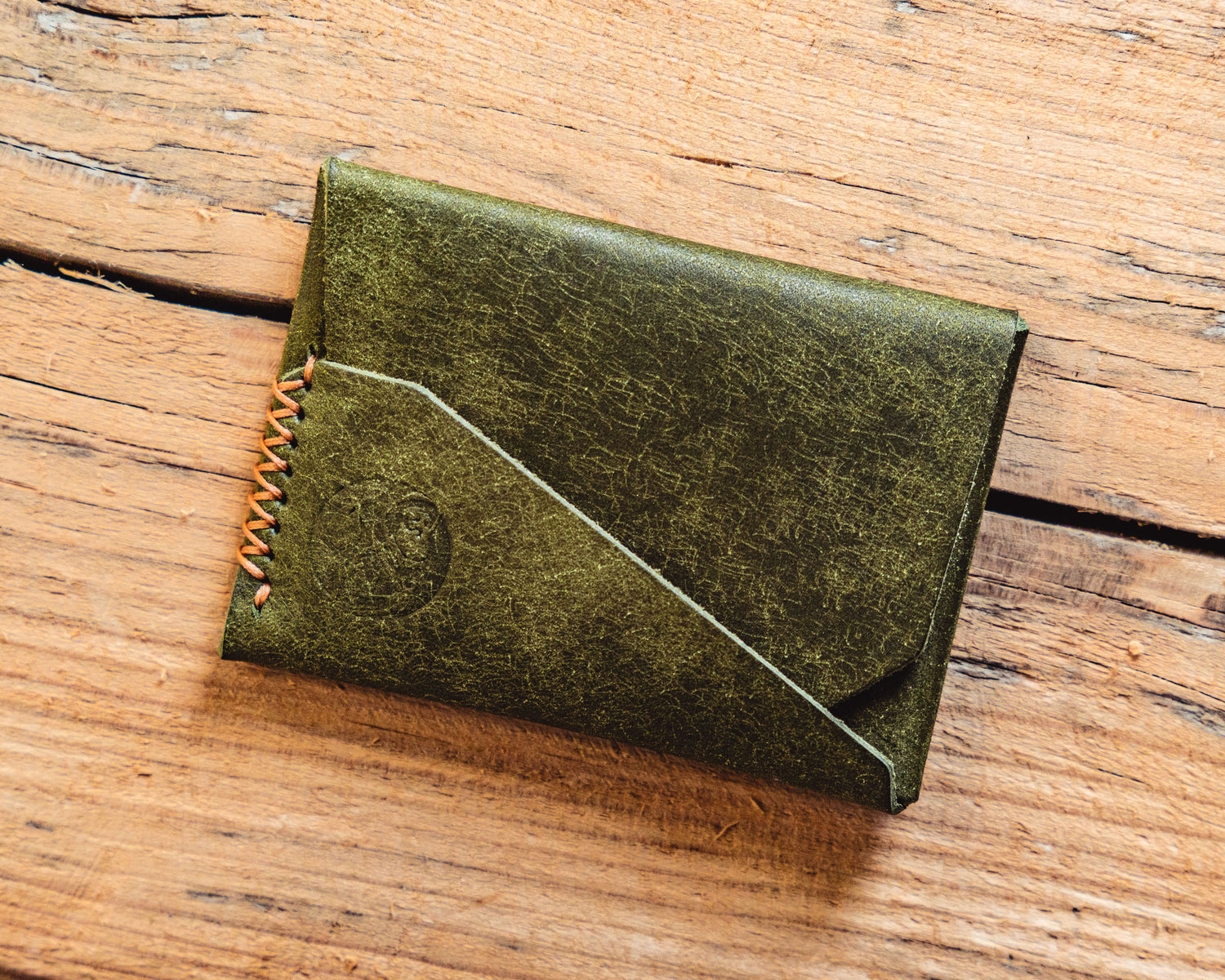 Carry Commission / Open Sea Leather Gun Deck Mini in olive front overhead view on wooden background