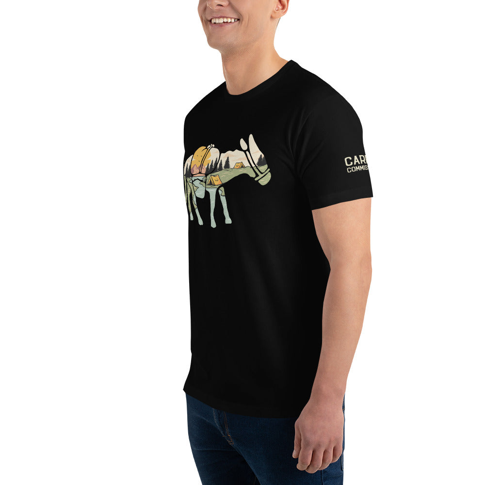 Front / side view of mean wearing a black t-shirt featuring a camping landscape scene contained inside a donkey silhouette with the left sleeve featuring the carry commission t-shirt