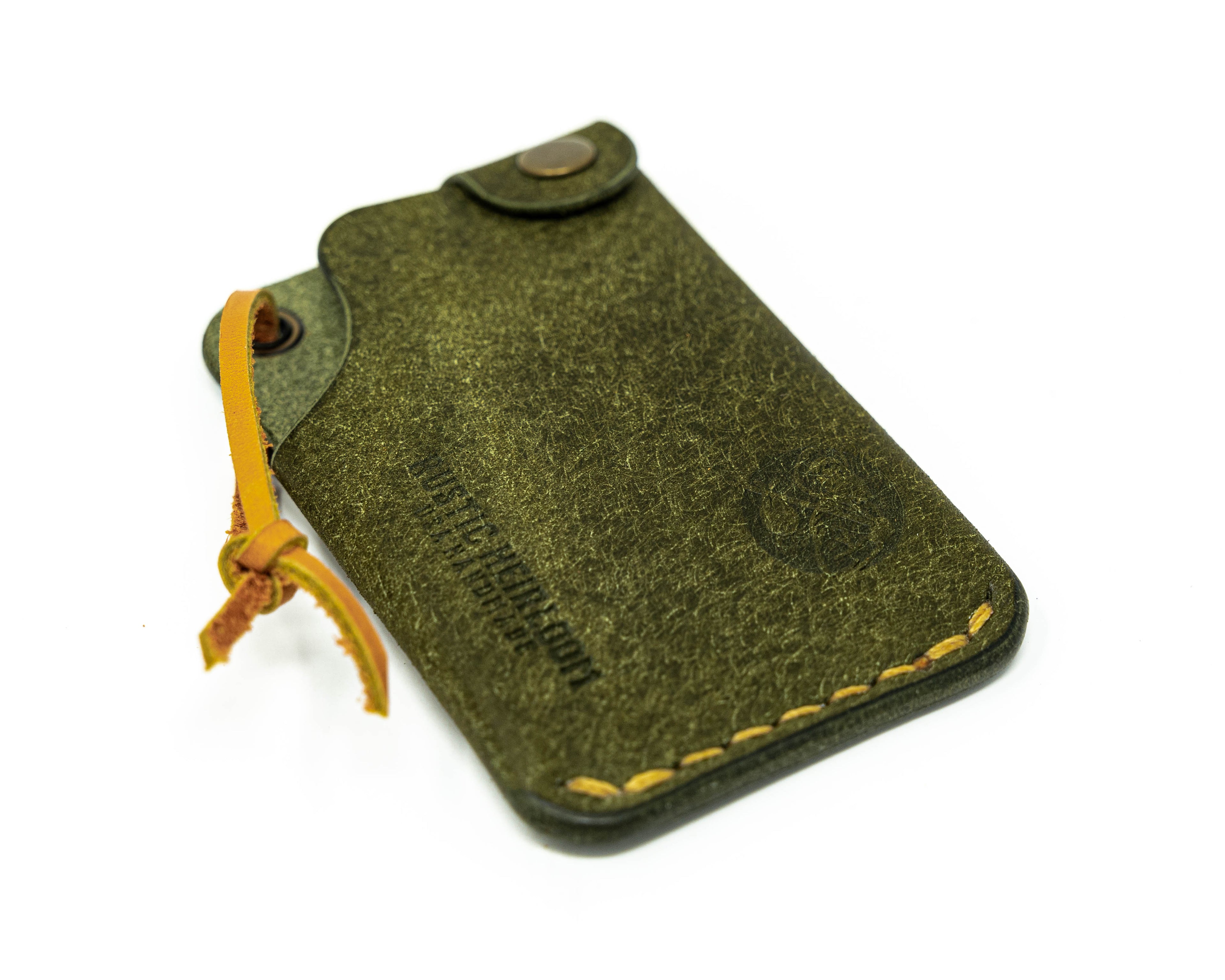 Top view of olive hitchhiker wallet slanted to the left on white background.