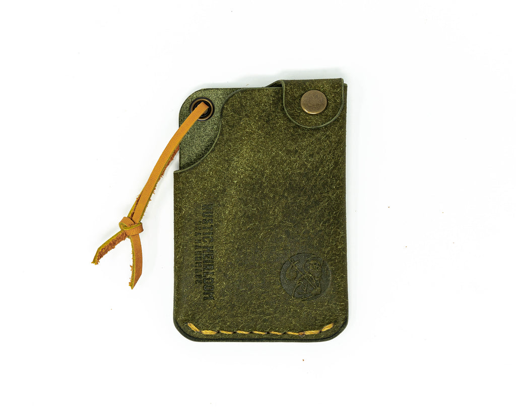 Top view of olive hitchhiker wallet on white background.