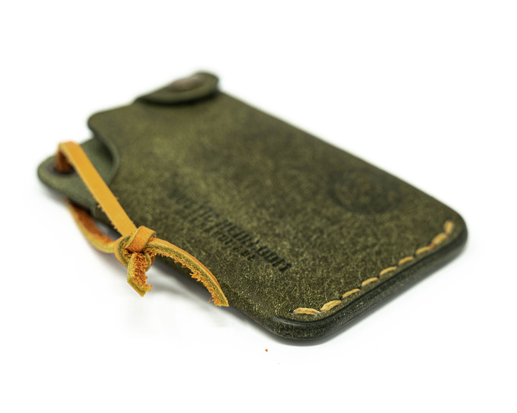Bottom left view of olive hitchhiker wallet on white background.