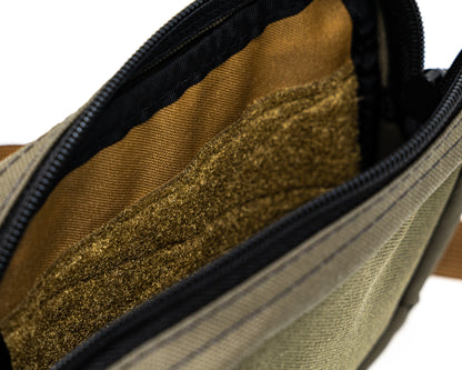 Close up overhead / interior view of bum bag in green and tan color way.