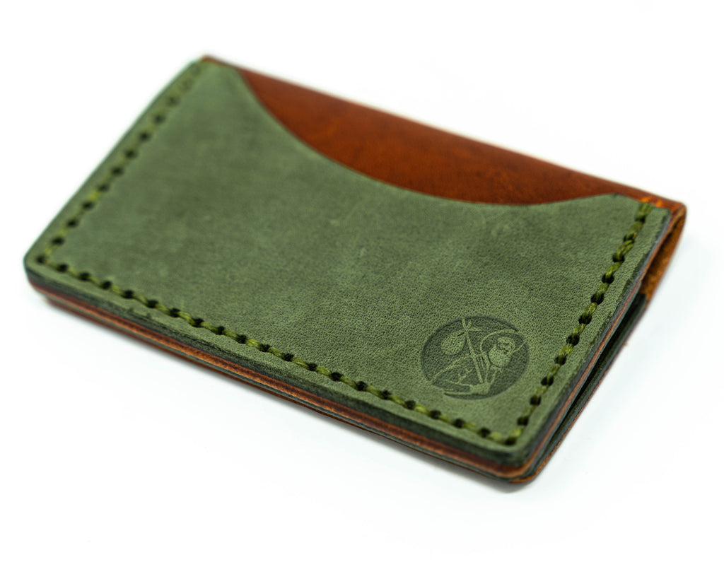 Offset overhead view of the back of a brown and green bifold wallet on a white background