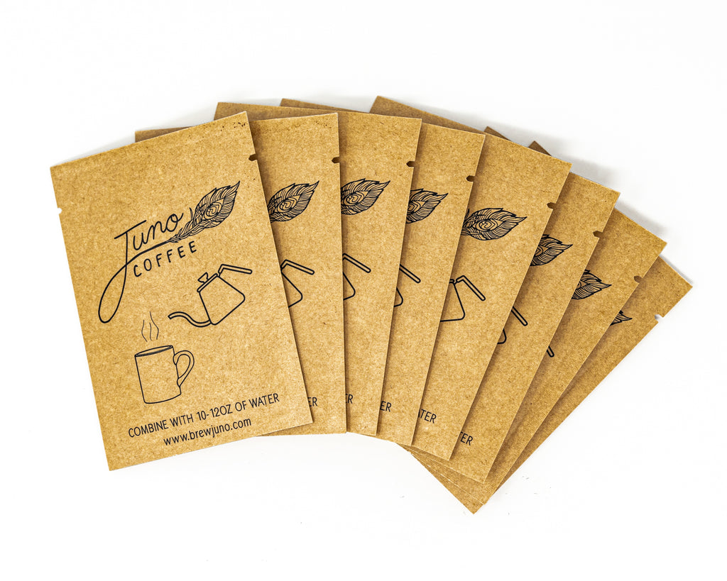 Packets of Juno Instant Coffee fanned out on a white background