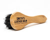 Smith's Leather Balm Horse Hair Dauber Brush laid on its side on white background. 