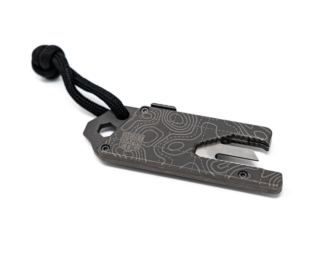 Side bottom angle view of Best Damn EDC TPT Slide Box Cutter Tool in Stonewash Topo