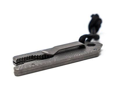 Overhead bottom back view of Best Damn EDC TPT Slide Box Cutter Tool in Stonewash Topo with pocket clip.