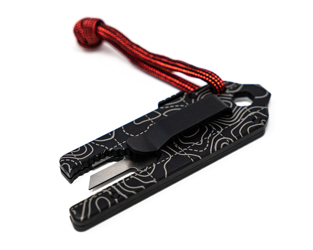 Overhead back angle view of Best Damn EDC TPT Slide Box Cutter Tool in Black Topo with pocket clip