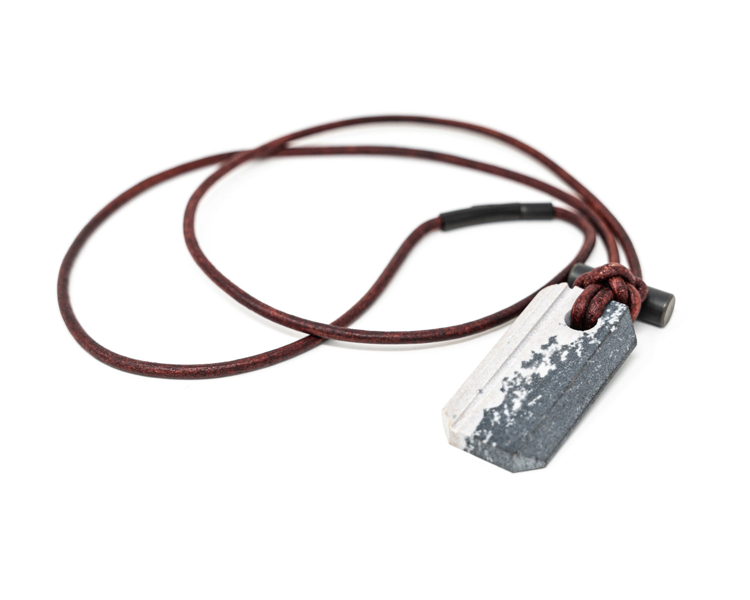 Overhead view of the Viking Spark necklace on a white background