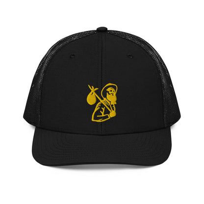 Front view of black trucker cap with Carry Commission logo of man holding bindle on shoulder in gold. 